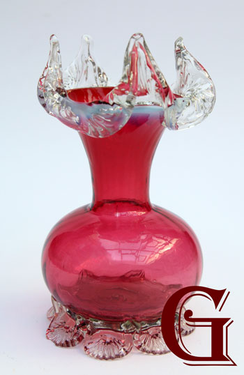 A cranberry vase with crystal frill