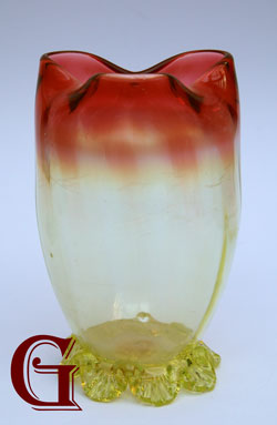 A cranberry opalescent and vaseline vase