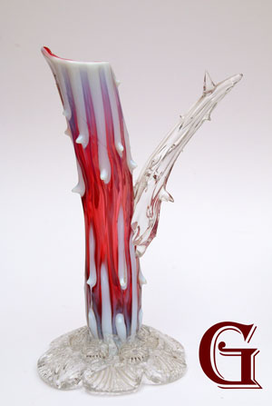 A cranberry opalescent rustic vase